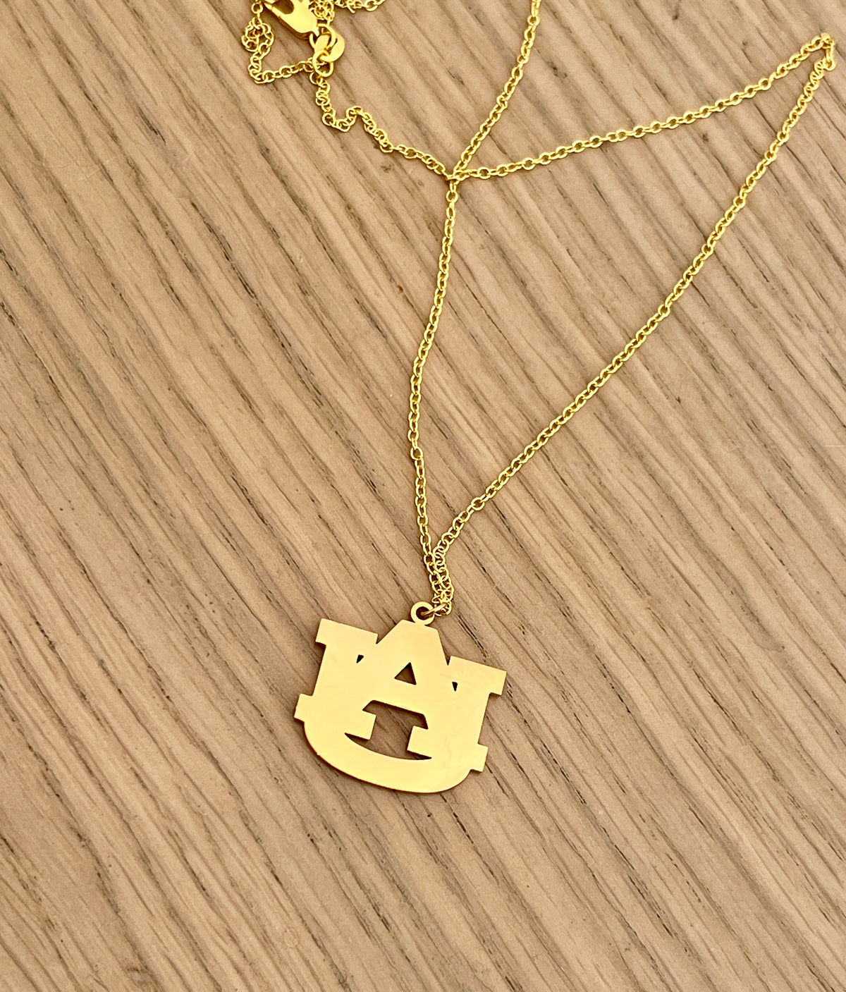Gold Auburn logo necklace, product view