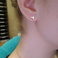 Hummingbird stud earrings worn on ear